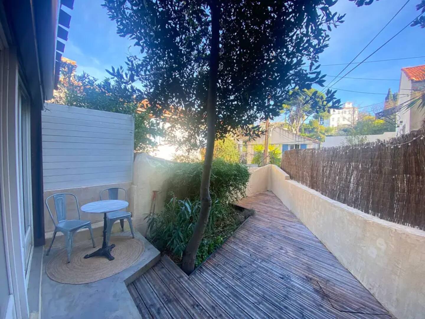 Private terrace with table, chairs and plants